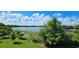 Expansive lake view with lush greenery and a picturesque sky, perfect for serene enjoyment at 593 Lake Wildmere Cv, Longwood, FL 32750