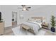 Serene bedroom featuring a ceiling fan, wood-look floors, ensuite bathroom and in-unit laundry at 920 S Solandra Dr, Orlando, FL 32807