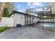 This home features a screened-in pool area, privacy fence, and a gray concrete patio area at 920 S Solandra Dr, Orlando, FL 32807