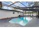 The screened-in pool features a blue tile border and the gray concrete deck at 920 S Solandra Dr, Orlando, FL 32807