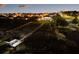 Aerial view of a community at dusk featuring lighted walking bridges and a covered boat dock at 13016 Shady Retreat Loop, Clermont, FL 34711