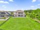 Aerial view of the expansive backyard, featuring a screened-in patio and pool at 13016 Shady Retreat Loop, Clermont, FL 34711