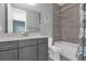 Modern bathroom with gray vanity and shower/tub combo at 13016 Shady Retreat Loop, Clermont, FL 34711