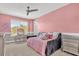 Bedroom with daybed and gray and pink color scheme at 13016 Shady Retreat Loop, Clermont, FL 34711