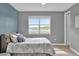 Cozy bedroom with lake view and patterned bedding at 13016 Shady Retreat Loop, Clermont, FL 34711