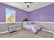 Bedroom with twin bed, nightstand, and purple walls at 13016 Shady Retreat Loop, Clermont, FL 34711