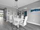 Dining room with modern white table, seating for six, and decor at 13016 Shady Retreat Loop, Clermont, FL 34711