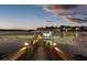 Nighttime view of dock on the lake, complete with boat lift, covered area, and charming walkway lights at 13016 Shady Retreat Loop, Clermont, FL 34711