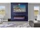 Modern electric fireplace with blue accent wall at 13016 Shady Retreat Loop, Clermont, FL 34711