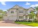 Two-story house with stone accents and three-car garage at 13016 Shady Retreat Loop, Clermont, FL 34711