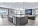 Modern kitchen island with sink and stainless steel appliances at 13016 Shady Retreat Loop, Clermont, FL 34711