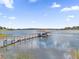 Lakefront property with private dock and boathouse at 13016 Shady Retreat Loop, Clermont, FL 34711