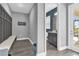 Mudroom with built-in bench seating, coat hooks, and access to a half-bathroom at 13016 Shady Retreat Loop, Clermont, FL 34711