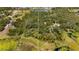 Aerial view of a wooded lot with waterfront access, perfect for building a private retreat at 2459 Adelia Blvd, Deltona, FL 32725