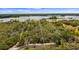Expansive wooded lot with lake access, offering privacy and potential for a waterfront home at 2459 Adelia Blvd, Deltona, FL 32725