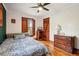 Bedroom with hardwood floors, a comfortable bed, and natural light from the wood-framed window at 2459 Adelia Blvd, Deltona, FL 32725