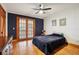 Bedroom featuring hardwood floors, dark accent wall and french doors at 2459 Adelia Blvd, Deltona, FL 32725