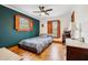 Cozy bedroom with hardwood floors, accent wall, and custom window trim at 2459 Adelia Blvd, Deltona, FL 32725