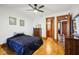 Bright bedroom featuring hardwood floors, dark trim, and a ceiling fan at 2459 Adelia Blvd, Deltona, FL 32725