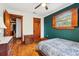 Bedroom with hardwood floors, custom door, and accent wall at 2459 Adelia Blvd, Deltona, FL 32725