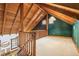 Upper level bonus room with vaulted wood ceilings, wooden railing, and a unique lighting fixture at 2459 Adelia Blvd, Deltona, FL 32725