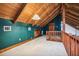 Upper level bonus room with vaulted wood ceilings, storage doors, green walls and carpeted flooring at 2459 Adelia Blvd, Deltona, FL 32725