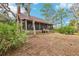 Charming screened porch, complemented by mature trees and natural surroundings at 2459 Adelia Blvd, Deltona, FL 32725