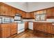 Traditional kitchen with wood cabinets and modern appliances at 2459 Adelia Blvd, Deltona, FL 32725