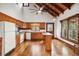 Bright and airy kitchen with wood cabinets, an island, wood floors, and an open design concept at 2459 Adelia Blvd, Deltona, FL 32725