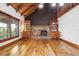Inviting living room featuring wood floors, a brick fireplace, and large windows providing natural light at 2459 Adelia Blvd, Deltona, FL 32725