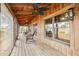 Inviting porch with rocking chairs, wooden flooring, and views of the surrounding trees and lake at 2459 Adelia Blvd, Deltona, FL 32725