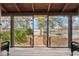 Covered porch with a view of the lawn, trees and landscape with a lake in the background at 2459 Adelia Blvd, Deltona, FL 32725