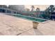 A community pool with a concrete deck in front of residential buildings at 4743 S Texas Ave # 4743B, Orlando, FL 32839