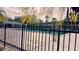 Community pool surrounded by a black fence and palm trees at 4743 S Texas Ave # 4743B, Orlando, FL 32839