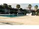 The community pool features clear water and mature palm trees at 4743 S Texas Ave # 4743B, Orlando, FL 32839