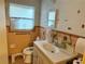 Clean bathroom with updated vanity and tiled walls at 6233 Balboa Dr, Orlando, FL 32808