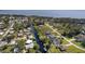 Aerial shot of a neighborhood featuring waterfront properties, homes with pools, and lush landscaping along a canal at 12009 Eagle Point Ct, Leesburg, FL 34788