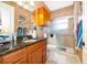 A full bathroom featuring dark countertops, a glass-enclosed shower, and tiled floors at 12009 Eagle Point Ct, Leesburg, FL 34788