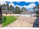 Long driveway to this home's garages; a garage with 2 bays and a separate one-car garage at 12009 Eagle Point Ct, Leesburg, FL 34788