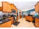 Kitchen features wooden cabinetry, granite countertops, and stainless steel appliances at 12009 Eagle Point Ct, Leesburg, FL 34788