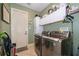 Laundry room featuring tile floors and modern washer and dryer units at 12009 Eagle Point Ct, Leesburg, FL 34788