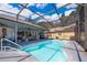Enjoy this pristine screened-in pool area with seating and shaded area at 12009 Eagle Point Ct, Leesburg, FL 34788