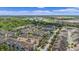 Community aerial shot features lush trees, blue skies, and a distant commercial center at 1349 Mill Stream Ln, Winter Springs, FL 32708