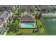 Aerial view of community pool surrounded by palm trees and overlooking a serene lake at 1349 Mill Stream Ln, Winter Springs, FL 32708
