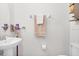 Bathroom featuring a white sink, toilet and wall-mounted shelving at 1349 Mill Stream Ln, Winter Springs, FL 32708