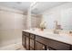 Bathroom featuring double sinks, dark wood cabinets, and a glass-enclosed shower at 1349 Mill Stream Ln, Winter Springs, FL 32708