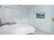 Cozy bedroom features a wall-mounted TV, a gray bed and neutral walls at 1349 Mill Stream Ln, Winter Springs, FL 32708