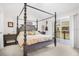 Bedroom with a four poster bed and a sliding glass door to a balcony at 1349 Mill Stream Ln, Winter Springs, FL 32708