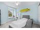 Light blue bedroom with a modern bed and a surfboard at 1349 Mill Stream Ln, Winter Springs, FL 32708