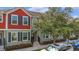 Charming townhome featuring a colorful exterior with black shutters, inviting curb appeal, and manicured landscaping at 1349 Mill Stream Ln, Winter Springs, FL 32708